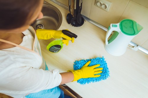 Technician performing carpet cleaning in a home