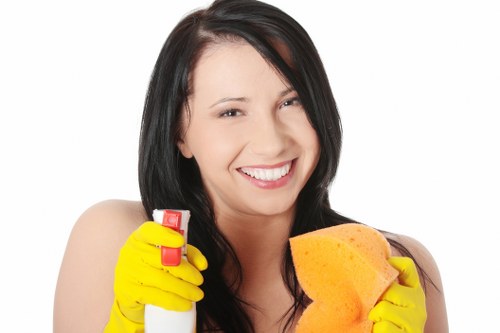 Professional cleaners sanitizing high-touch surfaces in a workplace
